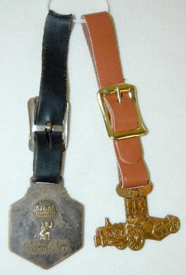 2 Watch Fobs - Older IH and Lorain: 2 Watch Fobs - Older IH and Lorain: 1.) IH in the form of an Earthmover; plated metal marked "Green Duck Co. - Chicago". 2.) The Lorain is showing a large Shovel Crane; made of plated metal; made for 