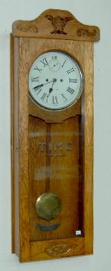 New Haven Oak 30 Day Wall Regulator Clock: New Haven Oak 30 Day Wall Regulator Clock: T & S with second hand bit; has a painted dial in an oak case; with the pendulum. 42" Long x 13 1/2" Wide (The dial is worn.) **Please note, this item ships