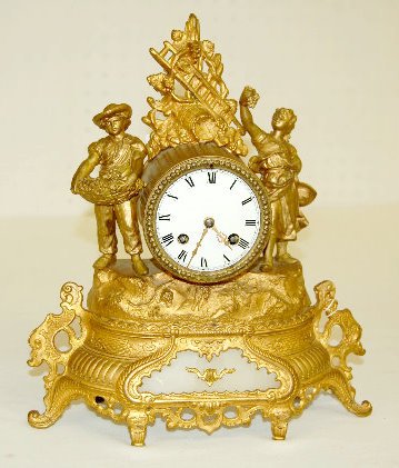 French Figural Novelty Clock: French Figural Novelty Clock: With an unsigned porcelain dial with Roman numerals; T & S movement #1120; has figures of a man and woman harvesting grapes; there is an onyx panel in the lower front; wi
