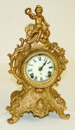 Ansonia "Cygnet" Novelty Clock: Ansonia "Cygnet" Novelty Clock: Has a signed porcelain dial with Roman numerals; 8 day T & S signed brass movement; with the pendulum and key. The clock is running at this time. 13" Tall