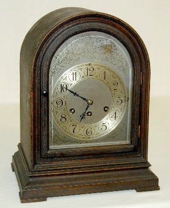 Herschede Westminster Chime Mantel Clock: Herschede Westminster Chime Mantel Clock: Has a silver colored metal face with Arabic numerals and floral decorations; T & S with 5 bar Westminster Chime; the case has a metal tag that reads "Hersched