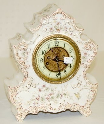 Waterbury China Shelf Clock: Waterbury China Shelf Clock: 8 day, T & S, porcelain chapter ring dial with open visible escapement, white case with violets and butterfly. Not tested. (Dial cracked, crazed all over. ) 11 1/2" x 8"