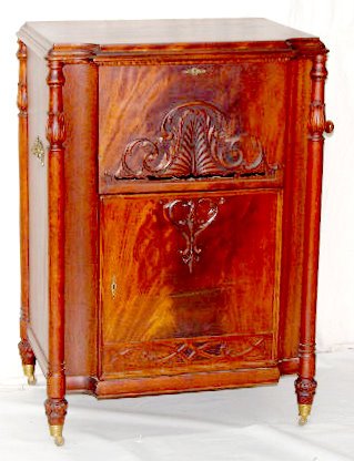 Stella Grand Console Mahogany Music Box: Stella Grand Console Mahogany Music Box: With 15 discs, the hand crank and door key; on castors. 42 1/2" Tall x 29 1/2" Wide x 21" Deep (There are 8 broken teeth on the comb.) **Please note, this item