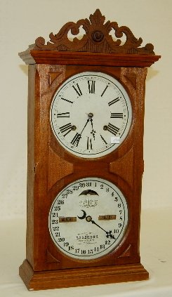 Ithaca "Calendar" Walnut Mantel Clock: Ithaca "Calendar" Walnut Mantel Clock: 8 day with gong strike; double dials; in a walnut case with paper label; with the pendulum. Not tested. 25 1/2" Tall (There is minor damage on the calendar dial.
