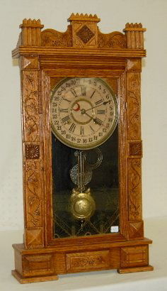 Gilbert "General" Oak Calendar Mantel Clock: Gilbert "General" Oak Calendar Mantel Clock: 8 day strike; in an oak case with leaf and vine decoration and a stenciled glass door; original partial label on the back; with the pendulum. Not tested. 2