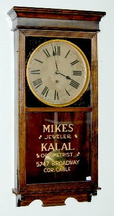 Sessions Advertising Store Regulator Clock, No. 2: Sessions Advertising Store Regulator Clock, No. 2: 8 day TO; with a recessed, paper dial; in a mahogany case advertising "Mikes Jeweler, KALAL, Optometrist 5747 Broadway, Cor. Gable". Not tested. 37 1