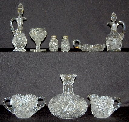 9 Pieces Cut and Pressed Glass Tableware: 9 Pieces Cut and Pressed Glass Tableware: Includes a Hobstar and Fan decanter; Whirling Hobstar cruet; wheelcut floral cruet; Star Button cut cream and sugar; Heart cut handled nappy; Loop Star presse