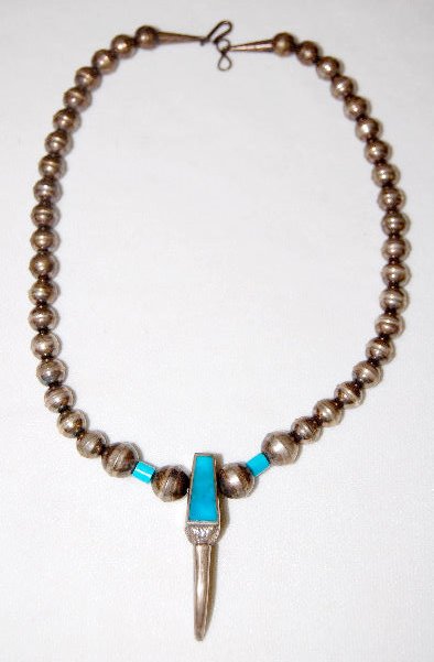 Necklace - Silver & Turquoise Bear Claw: Necklace - Silver & Turquoise Bear Claw: There are 21 hollow Silver balls 7.5 & 9.5 MM in size on each side of a Silver claw with Turquoise insert. 16" Long No condition problems.