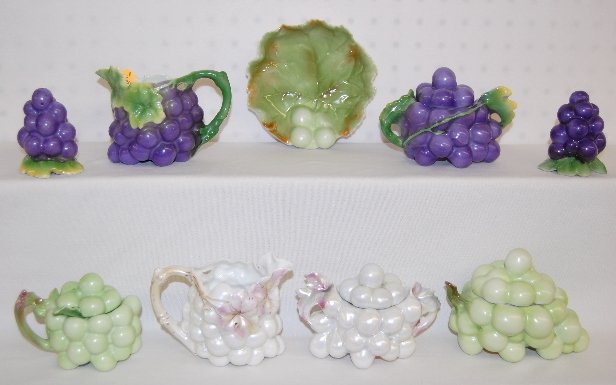 9 Pcs Royal Bayreuth Colored Grape Tableware: 9 Pcs Royal Bayreuth Colored Grape Tableware: There is a purple creamer, covered sugar and a salt and pepper. There is a green mustard pot with a ladle, a leaf bowl and a covered box. There is also a 