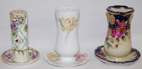 3 Nippon and Bavaria Hatpin Holders: 3 Nippon and Bavaria Hatpin Holders: Nippon with rose floral and gold decorations; Nippon violet with Moriage decoration; Bavaria with pink and yellow roses. Tallest 4 7/8" There are no condition prob