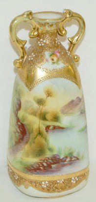 Hand Painted Nippon Scenic Vase: Hand Painted Nippon Scenic Vase: Mountain stream scenery with gold decoration around the base and the two handled top; marked on the bottom. 9" Tall (There is some gold wear on the handles.)