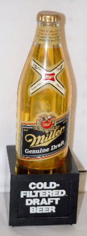 Miller Draft Beer Bottle Bar Light: Miller Draft Beer Bottle Bar Light: It is a plastic bottle set upon a square base; electric. 10 1/2" Tall This light has not been tested for working condition.