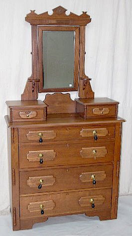 Antique Walnut 6 Drawer Dresser w/Mirror: Antique Walnut 6 Drawer Dresser w/Mirror: There are 4 large lower drawers with drop pulls plus 2 small handkerchief drawers with metal knobs; the mirror with candle stands and a crest. 79" Tall x 42"