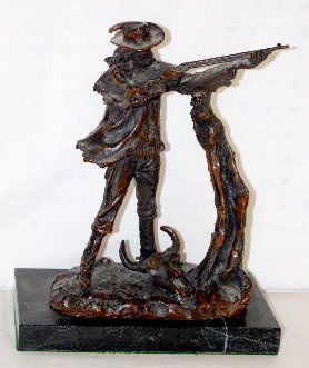 M. Russell Buffalo Hunter Bronze Figure: M. Russell Buffalo Hunter Bronze Figure: This contemporary piece is of a hunter with a long gun braced against a tree with a buffalo skull at his feet; on a marble base. 11 1/2" Tall There are no cond