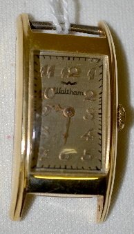 Waltham 14K 21J Riverside Wrist Watch, Minus Band: Waltham 14K 21J Riverside Wrist Watch, Minus Band: There is a rectangular silver dial with applied gold features; it is temperature adjusted; Serial No. 29398249. In a 14K yellow gold Harbor case No.