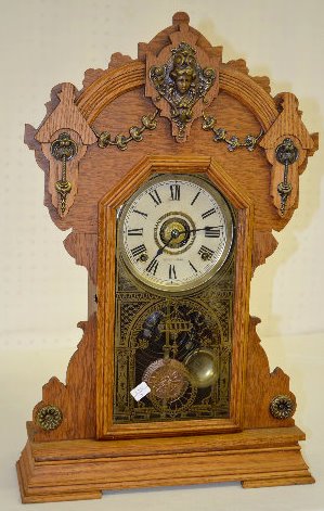 Seth Thomas Oak Metal Series No. 2 Clock: Seth Thomas Oak Metal Series No. 2 Clock: With an 8 day T&S with alarm, with 1/2 hour strike, movement and a marked paper dial. The door is stenciled with an arched doorway and a hanging swag with lar