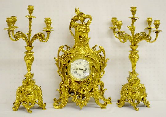 A.D. Mougin Bronze Dragon Clock Garniture Set: A.D. Mougin Bronze Dragon Clock Garniture Set: The dial, with Roman Numerals, has a band of Arabic numbers in 5 minute increments around it. The bell striking movement is also numbered 774. The highly