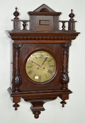 Carved German T&S Wall Clock: Carved German T&S Wall Clock: With an unmarked silver colored etched dial in a mahogany case. The pendulum is with the clock. Not tested. (There is no key with the clock.) 34" Tall Sells as is, where 