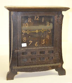 "Shop of the Crafters" Mission Clock #1: "Shop of the Crafters" Mission Clock #1: The dial is marked "New Haven Clock Co." which is "Los Santos" model with an 8 day T&S movement. In an oak case with raised cast numerals and fancy hands. The 