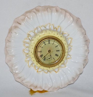 New Haven Porcelain Flower Shaped Novelty Clock: New Haven Porcelain Flower Shaped Novelty Clock: With a set key wind movement; a marked dial with 2nds bit and beveled glass - hangs from a chain. (The clock is not running.) 7" Diameter Sells as is,