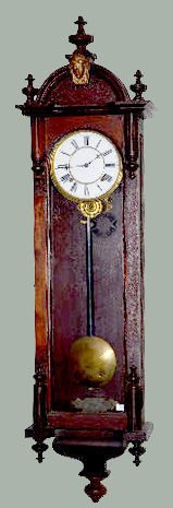 Ansonia "Capitol" Wall Regulator Clock: Ansonia "Capitol" Wall Regulator Clock: In a walnut case with glass sides; an 8 day T&S movement and an unmarked porcelain dial. Not tested. 54" Tall Sells as is, where is. **Please note, this item sh