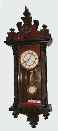 German R.A. Wall Clock w/Cherub & Posts: German R.A. Wall Clock w/Cherub & Posts: With an 8 day T&S movement; an unmarked porcelain dial and a RA pendulum. The case has a carved cherub on the crest and carved posts on the door. Not tested. (