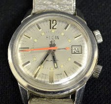 Elgin/Swiss 12 J No. 945 Wrist Watch w/Alarm: Elgin/Swiss 12 J No. 945 Wrist Watch w/Alarm: The DOM is displayed on the silver dial with silver features and orange alarm and seconds hand. The Stainless Steel case has a nice flex band on it. Sells