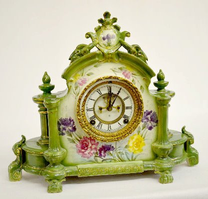 Ansonia "La Champagne" Green China Clock: Ansonia "La Champagne" Green China Clock: T & S; marked "A" porcelain chapter ring dial with visible escapement; has pendulum and key; case marked Royal Bonn La Champagne; carnations on a grre backgro
