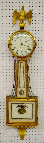 E. Howard & Co. S. Willard Patent Banjo Clock: E. Howard & Co. S. Willard Patent Banjo Clock: With a weight driven TO movement; a marked "Howard" dial; in a gilt and mahogany case with a gilt gesso eagle finial, the weight and pendulum. The lower 