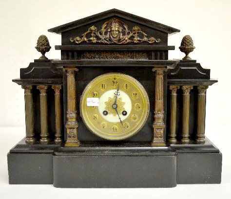 French Black Slate Mantel Clock: French Black Slate Mantel Clock: With a T&S movement marked "Made in Paris" and "G&B 12434"; a lady head ornament with pineapple finials; warrior frieze; four columns on each side and the pendulum. (T