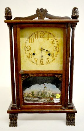 Half Size Pillar Clock with Paw Feet: Half Size Pillar Clock with Paw Feet: With a New Haven T&S movement; a painted metal dial; and in a case with the Springfield, Illinois State House on the lower door; acorn finials; 2 pillars and 2 ha