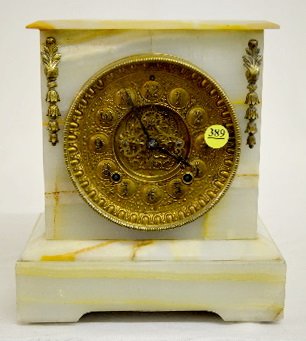 Gilbert Onyx Mantel Clock, Fancy Brass Dial: Gilbert Onyx Mantel Clock : With a signed T&S movement; an ornate metal dial with raised numerals and visible escapement; the pendulum and key. Not tested. (The clock backwinds - the click spring is b