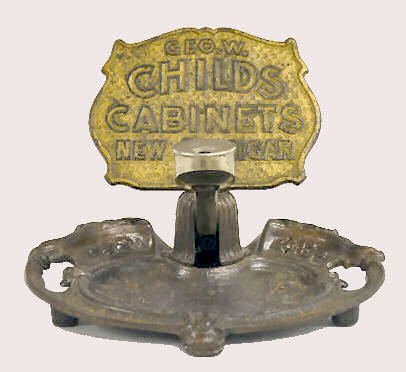 Counter Top Cigar Cutter, "Geo. W. Child's": Counter Top Cigar Cutter, "Geo. W. Child's": All metal; the front reads "Geo. W. Child's Cabinets New 5? Cigar". The cutter is marked "Finger Rest Pat. Appld For". The base is an Art Nouveau floral tr