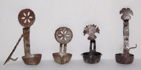 4 Antique Metal Betty Lamps: 4 Antique Metal Betty Lamps: 1.) Tall with wheat shock shaped top and attached spike. 2.) Short with wheat shock top and no spike. 3.) Tall with round top with a serrated edge, a floral center and an