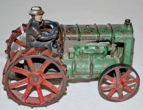 Arcade Cast Iron Fordson Tractor with Driver: Arcade Cast Iron Fordson Tractor with Driver: There is a partial paper label on the side of the tractor. The body is green and the wheels are red. The paint appears to be original. (Although the drive