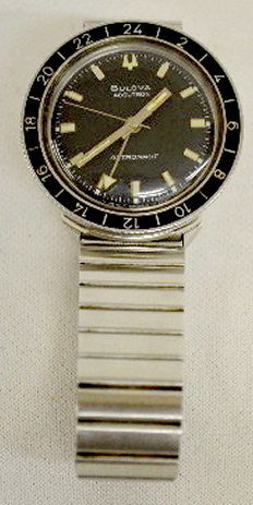 Bulova Accutron Astronaut Wrist Watch, in O.B.: Bulova Accutron Astronaut Wrist Watch, in O.B.: Stainless steel, No. 1-642782, circa 1968. The round black dial has white and silver features and a 24 Hour bezel, the band is original. There is a plas