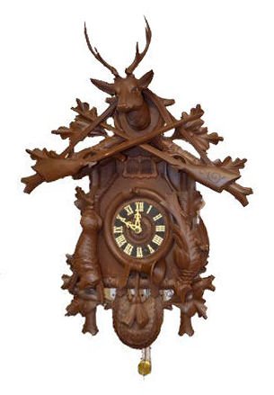 Lrg. Walnut German Carved Cuckoo Clock w/Deer: Lrg. Walnut German Carved Cuckoo Clock w/Deer: With deer head, quail, rabbit, crossed guns, 2-door cuckoo, brass pendulum and 3 Weights. 30" Tall; 21 1/2" Wide Not tested. Sells as is, where is.