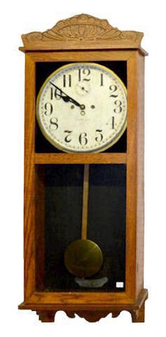 New Haven 30 Day Wall Regulator Clock, Oak: New Haven 30 Day Wall Regulator Clock, Oak: In a "Tampa" case with brass trim, a T & S movement and a marked dial with seconds bit. (There is minor roughness to the dial.) 44" Tall Not tested. Sells a