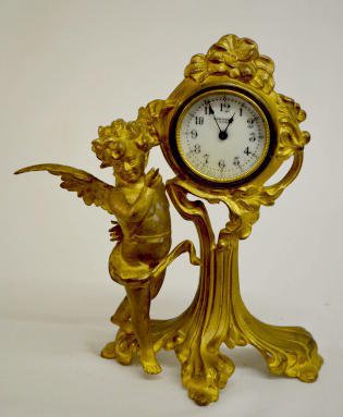 New Haven Dinsmore Cherub Novelty Clock: New Haven "Dinsmore" Cherub Novelty Clock: With a marked porcelain dial and a winged cherub. (There are minor patina issues.) Not tested. Sells as is, where is.