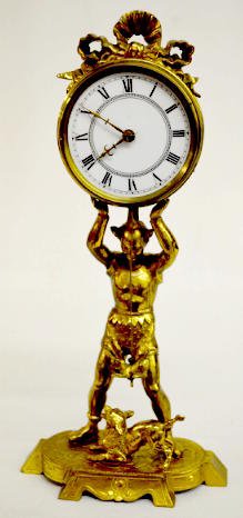 French Brass Figural Clock w/Jester & Dog: French Brass Figural Clock w/Jester & Dog: The jester is holding up the tab wind clock which has a porcelain dial. There is a dog at his feet. The pendulum is dog-shaped. Not tested. Sells as is, wher
