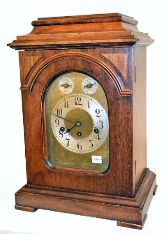 Junghans Musical Antique Bracket Clock: Junghans Musical Antique Bracket Clock: 1/4 hour strike; 5 rod chime; ornate dial plate. (Minor scuffs to dial and case.) 17"T x 12"W Sells as is, where is.