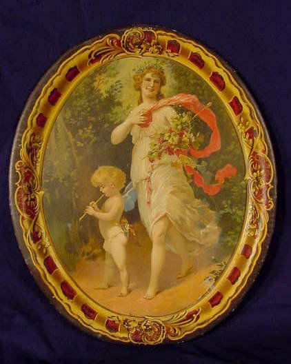 Tin & Lithograph Oval Tray NR: Tin and lithographed oval tray decorated with women and winged cherub playing the flute, made by H.D. Beach Co. Coshocton O. No. 1 (Some expected minor paint flaking around edges & white spots on surf