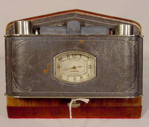 1926 -1929 Pierce Arrow Car Clock by Waltham NR: 1926 - 1929 Pierce Arrow Limousine car clock by Waltham Watch Co.; 8 day; rectangular with a 1 1/2" x 2" painted white oval dial; stem wind in an interior wall mount leather over nickel and metal case