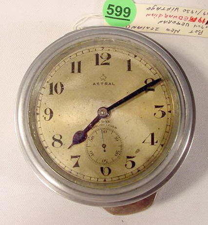 8 Day Astral Car Clock, England NR: Astral car clock, England; 8 day; 7 jewel; round with a 2 3/4" gold dial with seconds bit; rim wind in a dash mount metal case. (Worn dial in spots, hard to wind, non working) 3 1/2" All items are sol