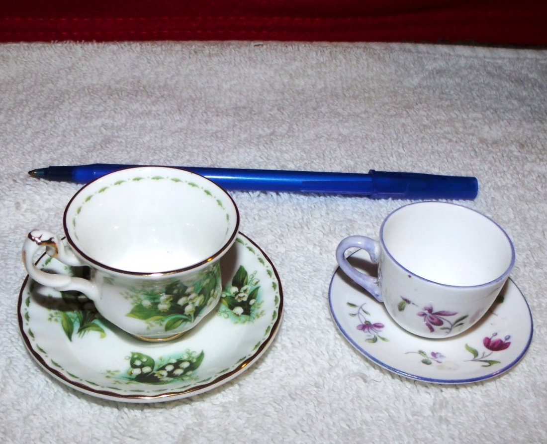 Shelley Miniature Tea Cup & Saucer: 1 Wonderfully whimsical Shelley China miniature tea cup and saucer in a pretty floral pattern trimmed with a lovely shade of a soft lavender. The set is a true miniature and are harder to find in this