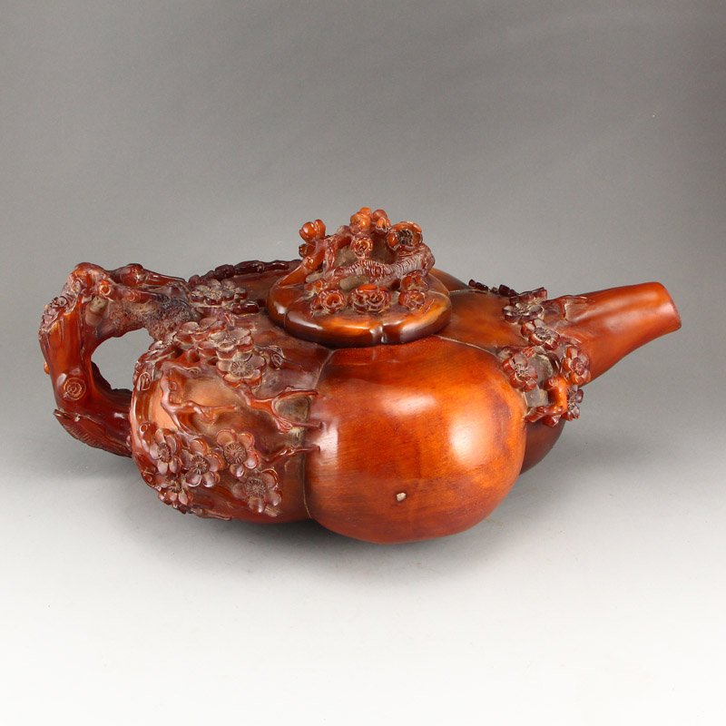 Ming Dynasty Ox Horn High Relief Plum Flower Big Teapot: Ming Dynasty ox horn teapot with Xuande mark. The high relief carvings depict beautiful plum flowers on the vibrantly red material. Dimension: 270x170x110 (mm) 10.63x6.69x4.33 (inches) Weight 3.21 lbs