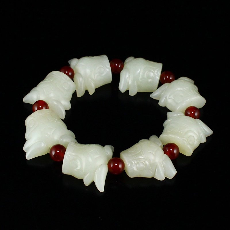 Chinese Hetian Jade Carved Ox Head Bracelet: Chinese Hetian Jade Carved Ox Head Bracelet Dimension: 21 x 26 x 12(mm) 0.83 x 1.02 x 0.47(inches) Weight: 0.18 lbs/84 g The wooden stand no included.