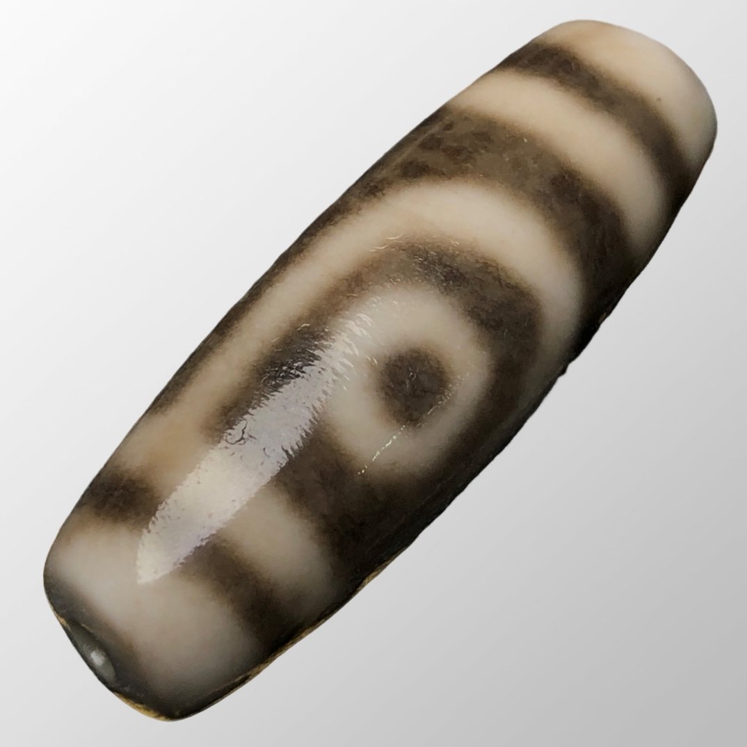 Old Tibetan 2 Eye DZI Agate Pendant: Old Tibetan 2 Eye DZI Agate PendantDimension:37 x 13 (mm)1.46 x 0.51 (inches) Weight:0.02 lbs/ 9.8 g