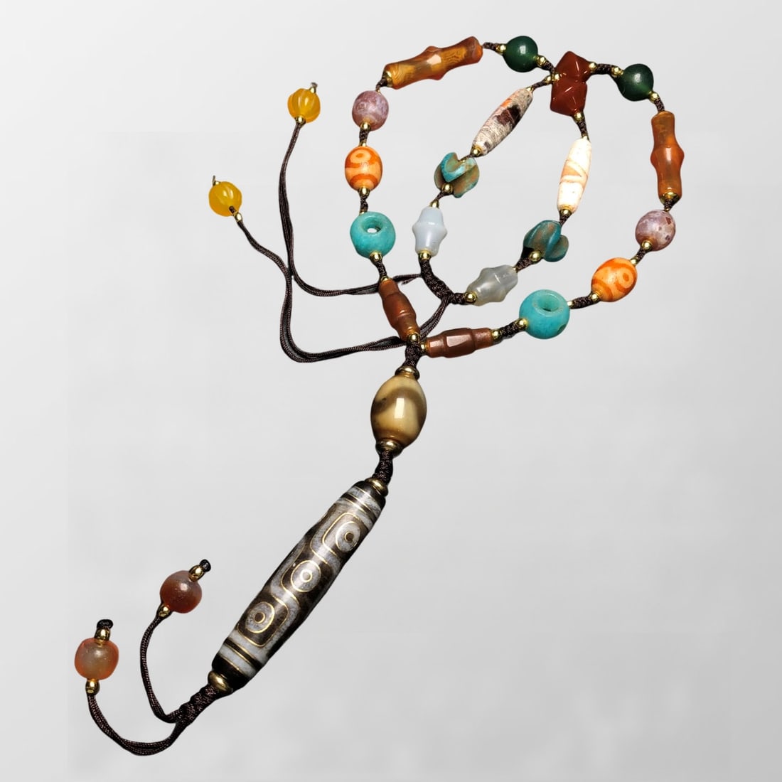 Tibetan 9 Eye DZI Agate Lucky Pendant w Hand Woven Beads Necklace: Tibetan 9 Eye DZI Agate Lucky Pendant w Hand Woven Beads NecklaceDimension: 57 x 13 (mm)2.24 x 0.51 (inches) Dimension: 13 x 12 (mm)0.51 x 0.47 (inches)