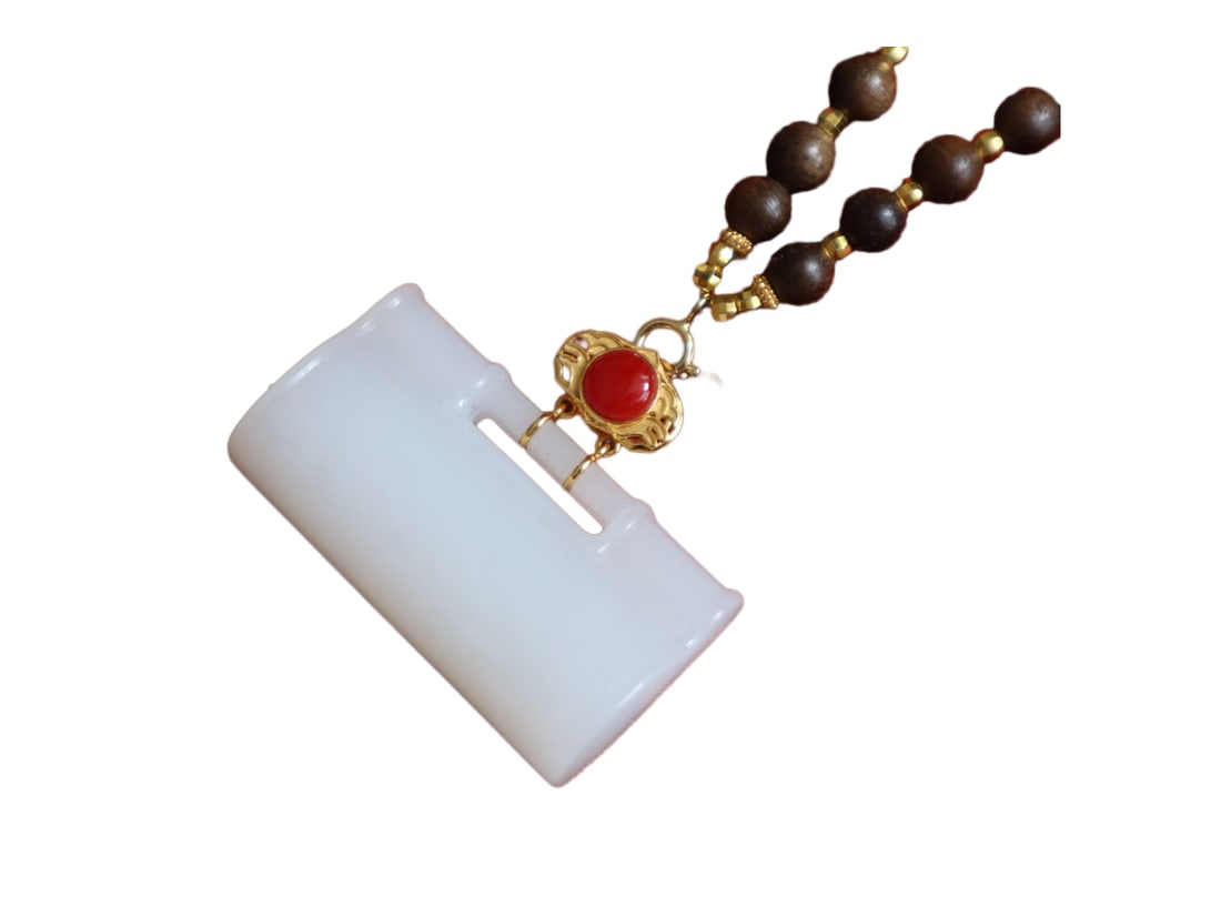White Hetian Jade Hand-Carved Ruyi Lock Pendant w 18K Gold Buckle & Chenxiang Wood Beads Necklace: Natural White Hetian Jade Hand-Carved Ruyi Lock Pendant w 18K Gold Buckle & Hand Woven Chenxiang Wood Beads NecklaceDimension: 36.2 x 20 x 11.7 (mm) 1.42 x 0.79 x 0.46 (inches)
